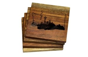 A set of four wooden coasters with the skyline of Seattle and the map of Washington