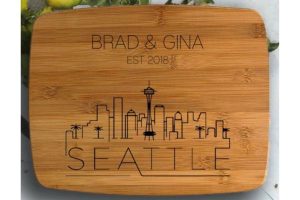 A wooden chopping board with a personalization and the skyline of Seattle
