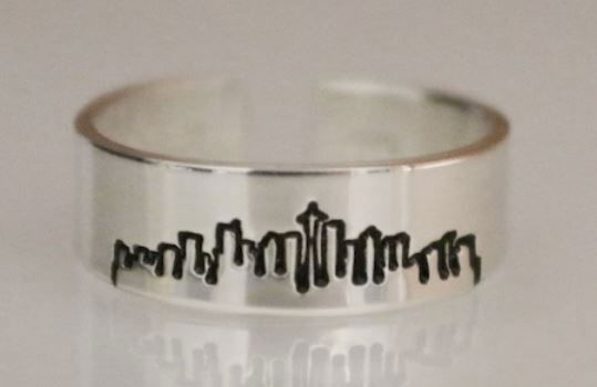 A ring with the skyline of Seattle etched