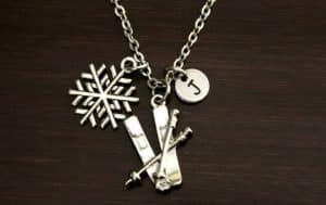 Necklace with a pendant of skis and a snowflake