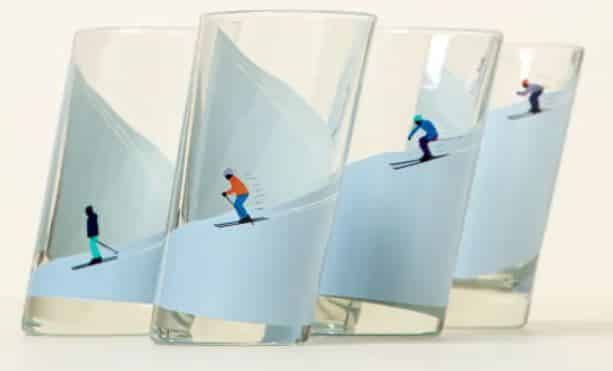 Four shot glasses with skiers going down a slope