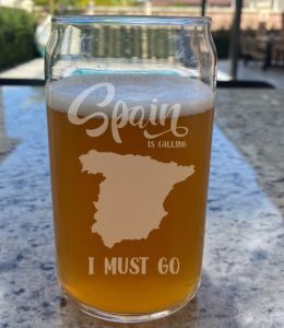 A beer glass with the etched text "Spain is calling and I must go"