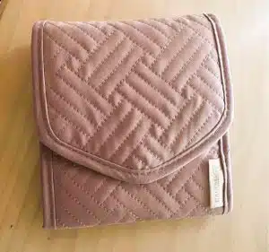 A pink wallet shaped jewelry organizer for travelers