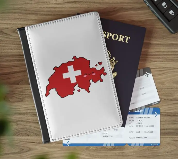 A white leather passport cover with the map and flag of Switzerland