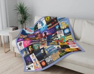 A blanket with different Broadway musical posters on a couch