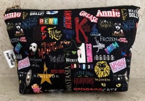 A make up bag with icons of famous Broadway shows