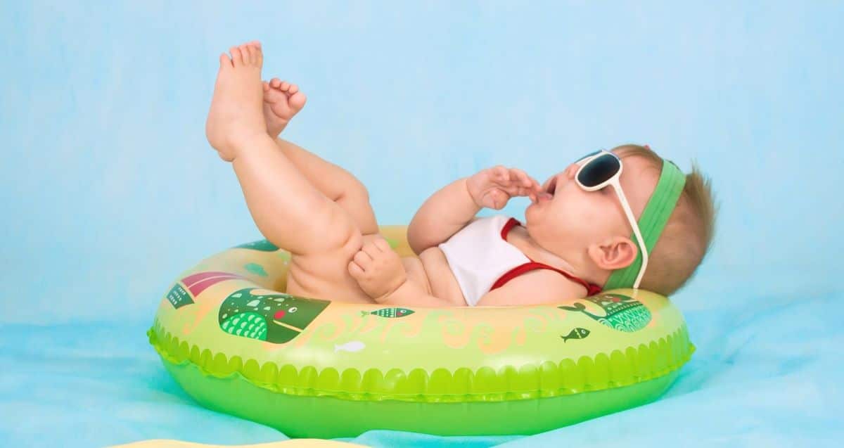 A baby lying on an inflatable pool toy