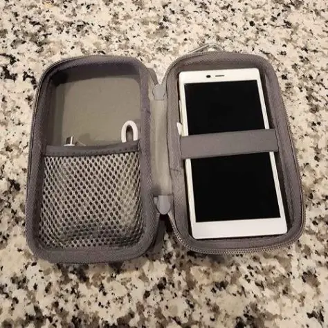 A grey holder for a white mobile hotspot