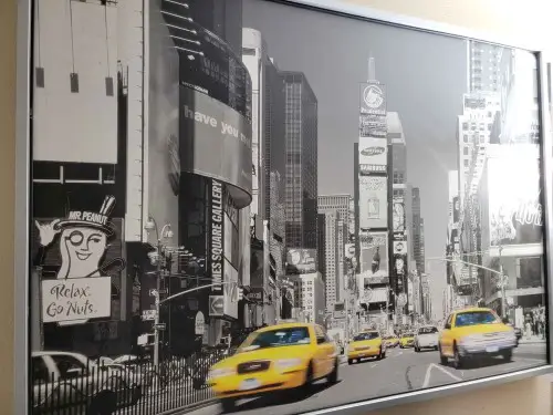 A travel poster of a busy street in New york with yellow cabs