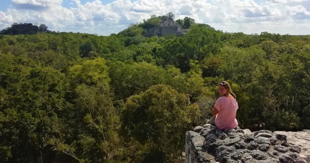 Woman sitting on ancient ruin