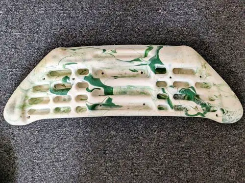 A hangboard for climbers with a paint drip pattern