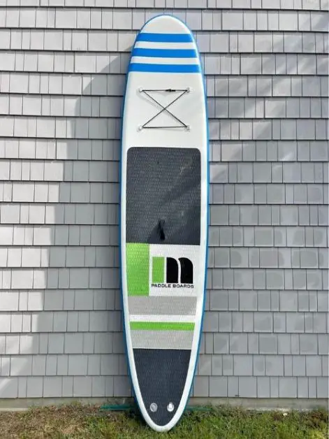 An inflatable paddle board against a wall