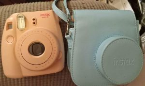 A pink poloroid with a bag