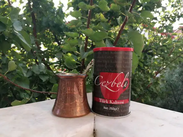 A Turkish coffee maker with an box of Turkish coffee