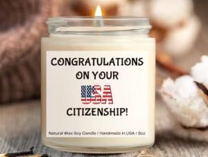 A candle with a label that says "Congratulations on your USA citizenship"