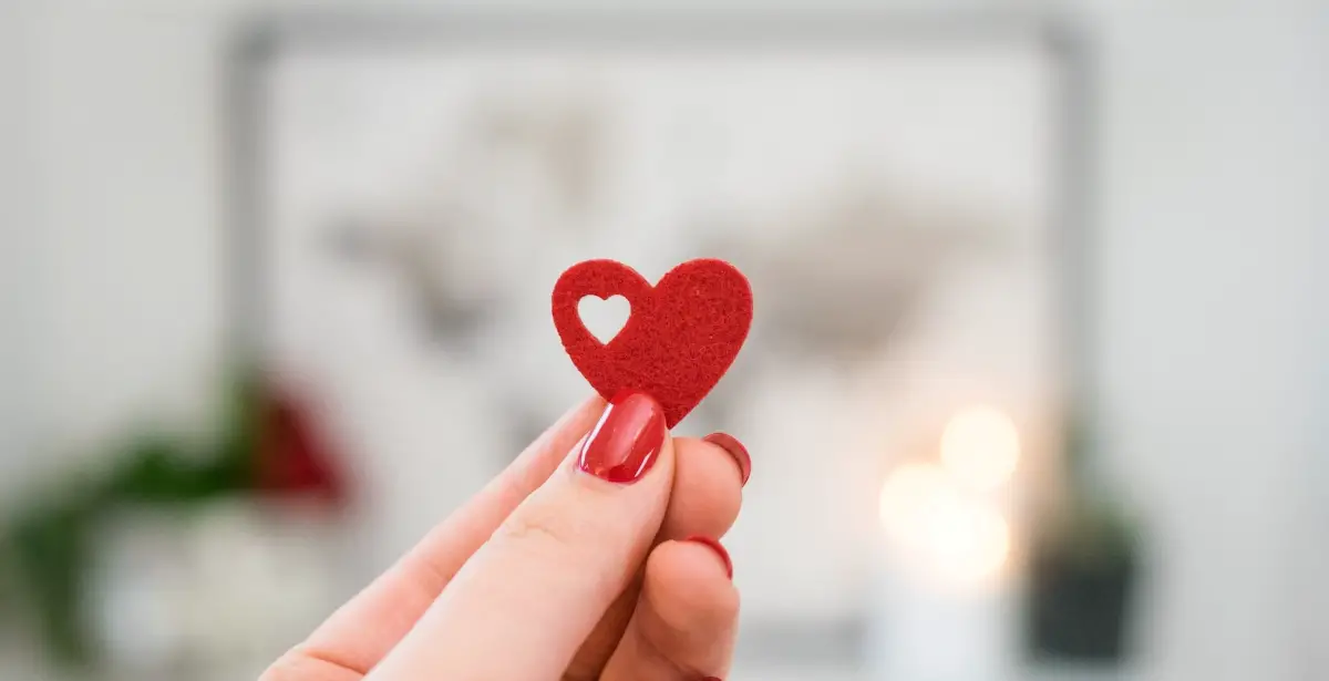 Hand holding a red heart