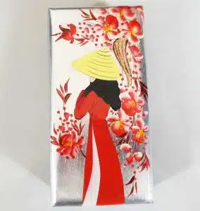 A handmade lacquer box from Vietnam with a decoration of a Vietnamese woman wearing a Vietnamese hat