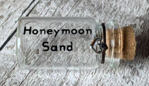 An empty bottle with the text "honeymoon sand"
